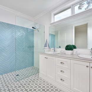 Photo of a beach style 3/4 bathroom in Melbourne with shaker cabinets, beige cabinets, an alcove shower, blue tile, beige walls, a drop-in sink, grey floor, an open shower and grey benchtops.