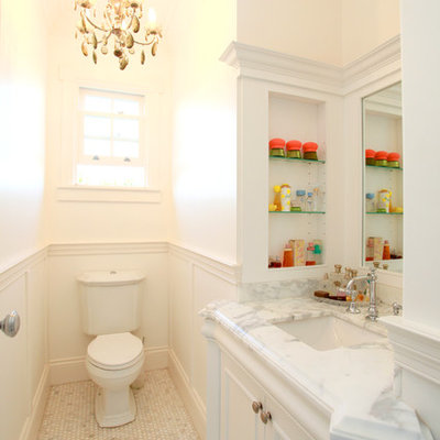 Inspiration for a mid-sized timeless white tile bathroom remodel in Brisbane with recessed-panel cabinets, marble countertops, a one-piece toilet and white walls