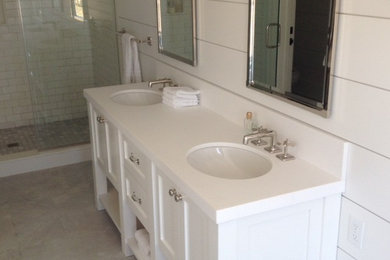 Example of a mid-sized transitional master white tile and subway tile gray floor bathroom design in New York with shaker cabinets, white cabinets, white walls, an undermount sink and quartzite countertops