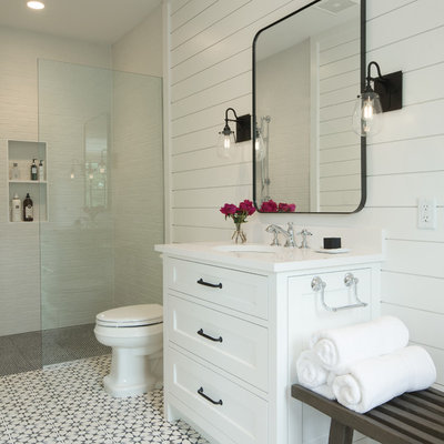 Example of a beach style 3/4 white tile white floor bathroom design in Minneapolis with quartz countertops, recessed-panel cabinets, white cabinets, white walls, an undermount sink and white countertops