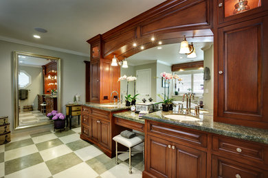 Inspiration for a large timeless master multicolored tile and stone tile limestone floor and multicolored floor bathroom remodel in Portland with an undermount sink, raised-panel cabinets, dark wood cabinets, a one-piece toilet, green walls, granite countertops, a hinged shower door and green countertops