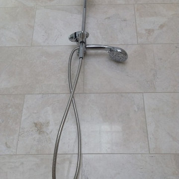 Hand held shower and 12 x 24 Crema Bella Polished Marble Tiles in a Roll in show