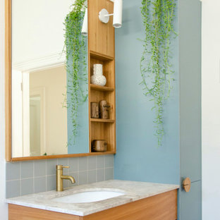 Scandinavian bathroom in Melbourne with flat-panel cabinets, medium wood cabinets, white walls, an undermount sink, grey benchtops, a single vanity and a floating vanity.