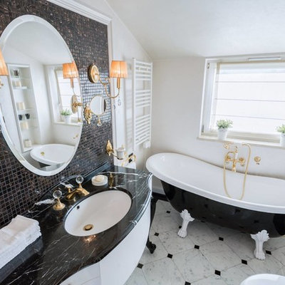 Inspiration for a mid-sized timeless brown tile and mosaic tile marble floor and gray floor claw-foot bathtub remodel in Other with flat-panel cabinets, white cabinets, beige walls and an undermount sink
