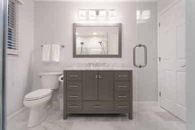 Medium sized contemporary ensuite bathroom in Philadelphia with shaker cabinets, grey cabinets, a double shower, a two-piece toilet, grey tiles, metro tiles, grey walls, marble flooring, a submerged sink and marble worktops.