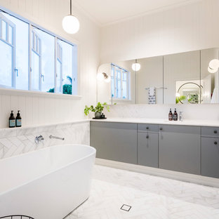 Design ideas for a transitional bathroom in Brisbane with limestone floors, marble benchtops, white floor and white benchtops.