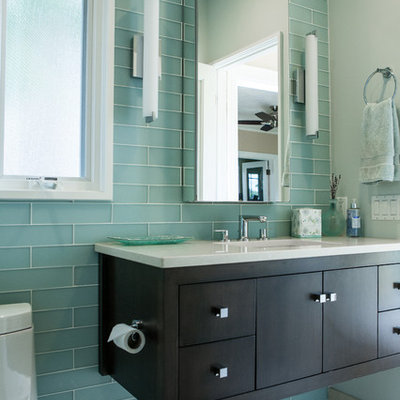Corner shower - small eclectic green tile and glass tile porcelain tile corner shower idea in New York with an undermount sink, flat-panel cabinets, dark wood cabinets, quartz countertops, a two-piece toilet and blue walls