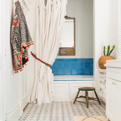 Inspiration for a mid-sized eclectic master blue tile and ceramic tile ceramic tile and multicolored floor bathroom remodel in Houston with shaker cabinets, white cabinets, white walls, a drop-in sink and a hinged shower door