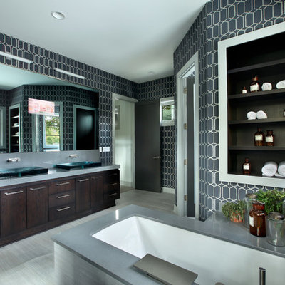 Large trendy master bathroom photo in Grand Rapids with a vessel sink, flat-panel cabinets, dark wood cabinets and an undermount tub