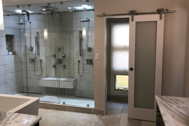 Inspiration for a large modern ensuite bathroom in Hawaii with a freestanding bath, a double shower, white tiles, porcelain tiles, grey walls, travertine flooring, a vessel sink, marble worktops, grey floors, a sliding door and grey worktops.