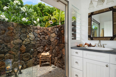 Inspiration for a tropical doorless shower remodel in Hawaii with a drop-in sink, white cabinets, recessed-panel cabinets and gray countertops