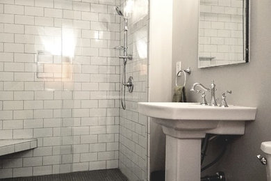Bathroom - mid-sized traditional 3/4 white tile and subway tile porcelain tile and black floor bathroom idea in Cleveland with a two-piece toilet, gray walls and a pedestal sink