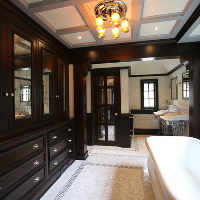 Elegant freestanding bathtub photo in New York with a console sink