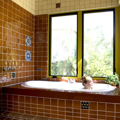 Mid-sized southwest brown tile, white tile and ceramic tile terra-cotta tile and red floor bathroom photo in Los Angeles with an undermount tub and quartz countertops