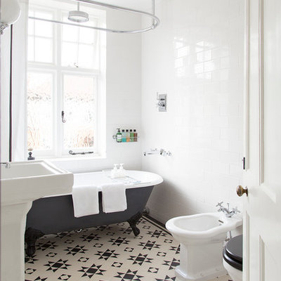 Mid-sized elegant white tile and subway tile ceramic tile bathroom photo in London with a bidet, white walls and a pedestal sink