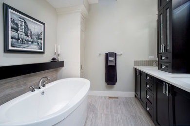 Bathroom - mid-sized transitional master beige tile and mosaic tile porcelain tile bathroom idea in Calgary with an undermount sink, recessed-panel cabinets, white cabinets, quartz countertops, a one-piece toilet and gray walls