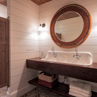 Photo of a mid-sized transitional 3/4 bathroom in Minneapolis with open cabinets, dark wood cabinets, white walls, brick floors, a trough sink, wood benchtops and red floor.