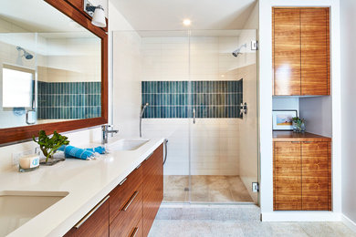 Inspiration for a transitional green tile and white tile alcove shower remodel in Los Angeles with medium tone wood cabinets and a vessel sink