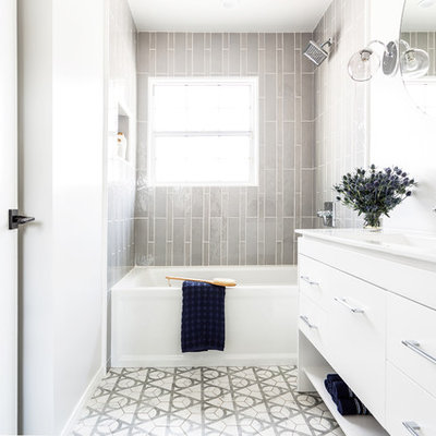 Example of a mid-sized trendy kids' gray tile and ceramic tile ceramic tile and gray floor bathroom design in Los Angeles with flat-panel cabinets, white cabinets, a one-piece toilet, white walls, an integrated sink, quartz countertops and white countertops