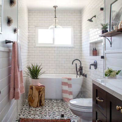 Mid-sized cottage 3/4 white tile and subway tile cement tile floor and black floor bathroom photo in Los Angeles with shaker cabinets, an undermount sink, brown cabinets, a two-piece toilet, gray walls and marble countertops