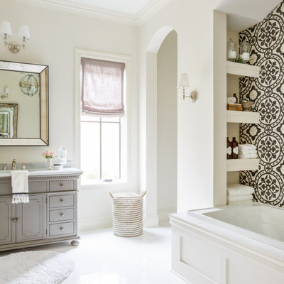 Drop-in bathtub - transitional master black and white tile and white tile white floor and single-sink drop-in bathtub idea in Jacksonville with recessed-panel cabinets, gray cabinets, an undermount sink, marble countertops, gray countertops and a built-in vanity