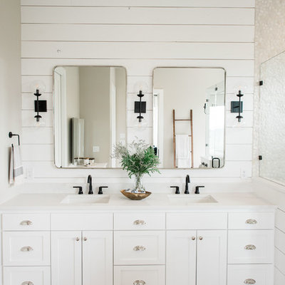 Inspiration for a large country master porcelain tile and gray floor bathroom remodel in Austin with shaker cabinets, white cabinets, white walls, a drop-in sink, quartz countertops, a hinged shower door and white countertops