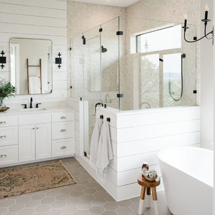 Inspiration for a large country master bathroom in Austin with shaker cabinets, white cabinets, a freestanding tub, a corner shower, white walls, porcelain floors, a drop-in sink, engineered quartz benchtops, grey floor, a hinged shower door and white benchtops.