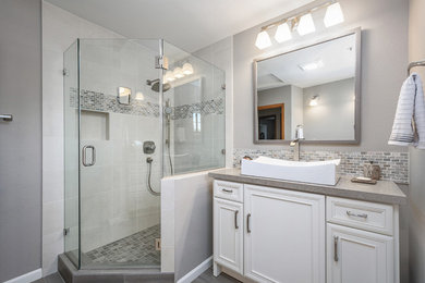 This is an example of a medium sized contemporary shower room bathroom in San Francisco with recessed-panel cabinets, a corner shower, a two-piece toilet, grey tiles, porcelain tiles, grey walls, porcelain flooring, a vessel sink, concrete worktops, grey floors and a hinged door.