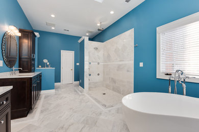 Example of a large classic master gray tile and marble tile marble floor and gray floor bathroom design in DC Metro with recessed-panel cabinets, dark wood cabinets, a two-piece toilet, blue walls, an undermount sink, marble countertops and gray countertops