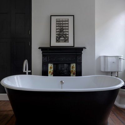 Mid-sized ornate kids' medium tone wood floor and brown floor bathroom photo in London with a two-piece toilet and gray walls