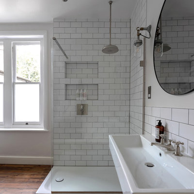 Bathroom - mid-sized victorian kids' medium tone wood floor and brown floor bathroom idea in London with a two-piece toilet, gray walls and a wall-mount sink