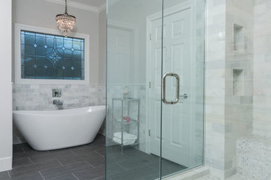 Example of a large classic master glass tile and gray tile porcelain tile bathroom design in Other with raised-panel cabinets, white cabinets, gray walls, an undermount sink and marble countertops