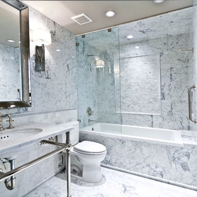 Example of a small eclectic master white tile and subway tile marble floor drop-in bathtub design in Houston with a pedestal sink, furniture-like cabinets, marble countertops and a two-piece toilet