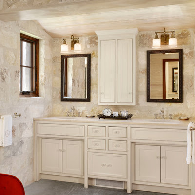 Inspiration for a cottage stone tile bathroom remodel in Houston with an undermount sink, beaded inset cabinets and beige cabinets