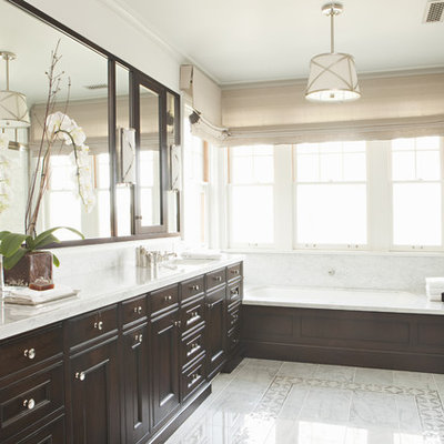 Elegant alcove bathtub photo in Los Angeles with recessed-panel cabinets and dark wood cabinets