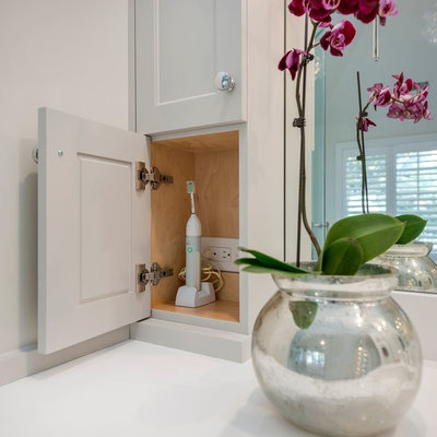 Example of a large transitional master white tile and stone slab marble floor bathroom design in Chicago with recessed-panel cabinets, white cabinets, white walls, an undermount sink and solid surface countertops