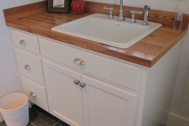 Bathroom - mid-sized transitional 3/4 white tile bathroom idea in Portland Maine with a trough sink, white cabinets, wood countertops and white walls