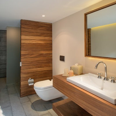 Inspiration for a mid-sized modern bathroom remodel in Mexico City with a vessel sink, a wall-mount toilet, wood countertops and brown countertops