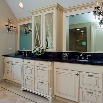 HIs and her sinks with distressed white cabinetry and large built-in mirrors