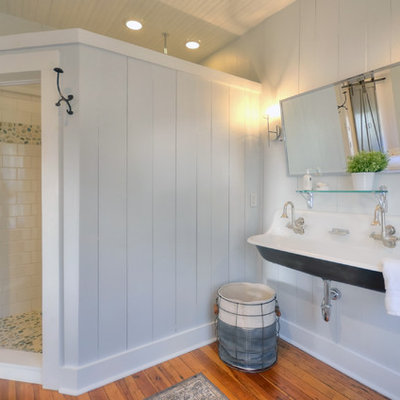 Corner shower - farmhouse medium tone wood floor corner shower idea in Other with gray walls and a trough sink