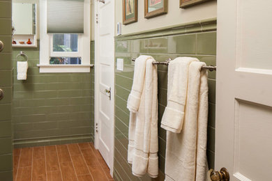 Medium sized traditional ensuite bathroom in San Diego with shaker cabinets, medium wood cabinets, an alcove shower, a two-piece toilet, green tiles, ceramic tiles, green walls, porcelain flooring, a submerged sink, engineered stone worktops, brown floors and a shower curtain.