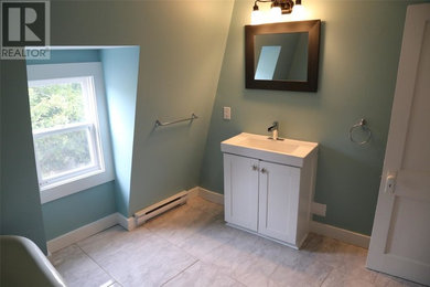 Claw-foot bathtub - mid-sized traditional master ceramic tile and gray floor claw-foot bathtub idea in Other with raised-panel cabinets, white cabinets, a two-piece toilet, blue walls, a drop-in sink, granite countertops and white countertops