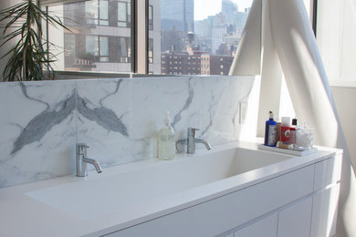 Mid-sized trendy master white tile and stone tile drop-in bathtub photo in New York with an integrated sink, flat-panel cabinets, white cabinets, solid surface countertops and white walls