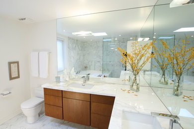 Пример оригинального дизайна: большая главная ванная комната в стиле модернизм с накладной раковиной, плоскими фасадами, фасадами цвета дерева среднего тона, мраморной столешницей, унитазом-моноблоком, разноцветной плиткой, плиткой из листового камня, белыми стенами и мраморным полом