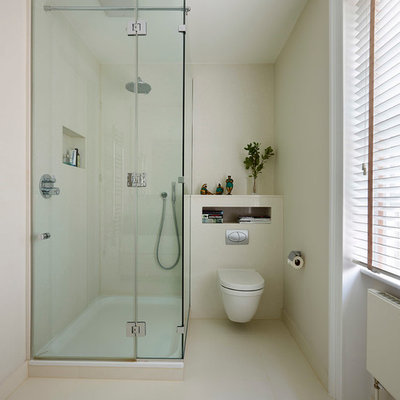 Corner shower - small victorian master white tile and porcelain tile porcelain tile corner shower idea in London with furniture-like cabinets, white cabinets, a wall-mount toilet and white walls
