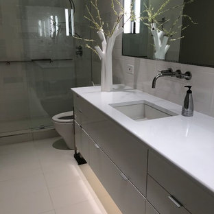 Inspiration for a small modern master bathroom in Dallas with glass-front cabinets, grey cabinets, an open shower, a one-piece toilet, white tile, ceramic tile, grey walls, porcelain floors, an undermount sink, engineered quartz benchtops, white floor, an open shower and white benchtops.