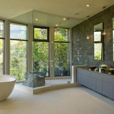 Example of a trendy freestanding bathtub design in Los Angeles with a vessel sink