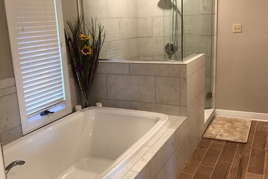 Inspiration for a master multicolored tile and ceramic tile cement tile floor and brown floor bathroom remodel in Richmond with shaker cabinets, white cabinets, a two-piece toilet, beige walls, an undermount sink, quartz countertops, a hinged shower door and white countertops