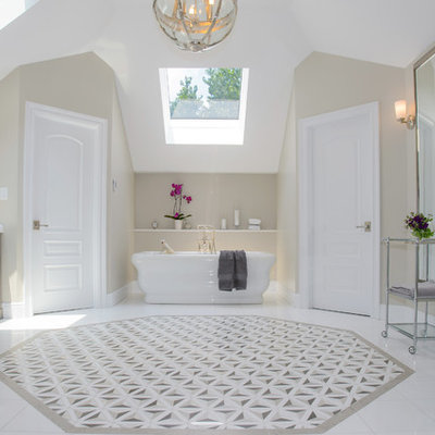 Inspiration for a timeless master beige tile and stone tile freestanding bathtub remodel in New York with raised-panel cabinets, gray cabinets and beige walls