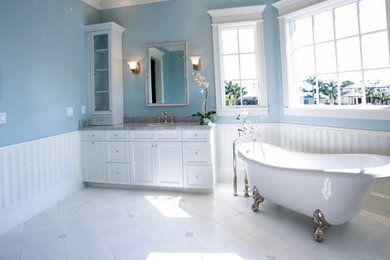 Inspiration for a mid-sized shabby-chic style master white tile ceramic tile claw-foot bathtub remodel in Phoenix with recessed-panel cabinets, white cabinets, blue walls and a drop-in sink